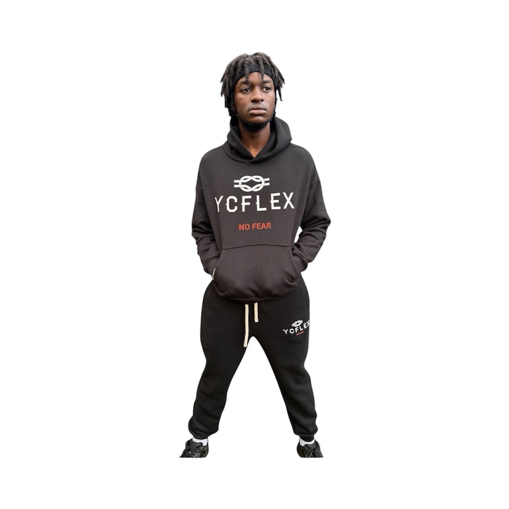 Person wearing a black hoodie with 'YCFLEX NO FEAR' text on a white background